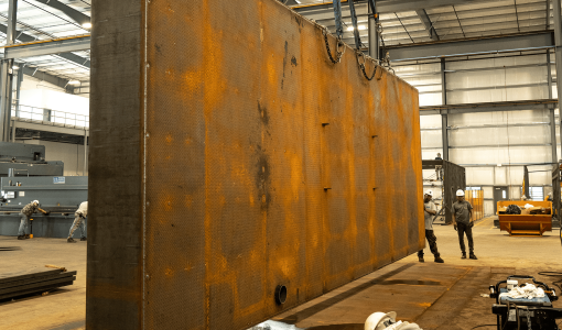 fuel tank being lifted by crane in manufacturing facility Acoustical Sheetmetal Company