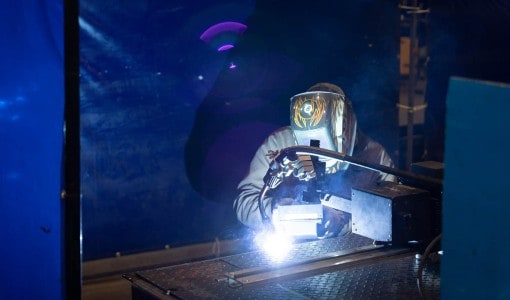 welder using track welder Acoustical Sheetmetal Company
