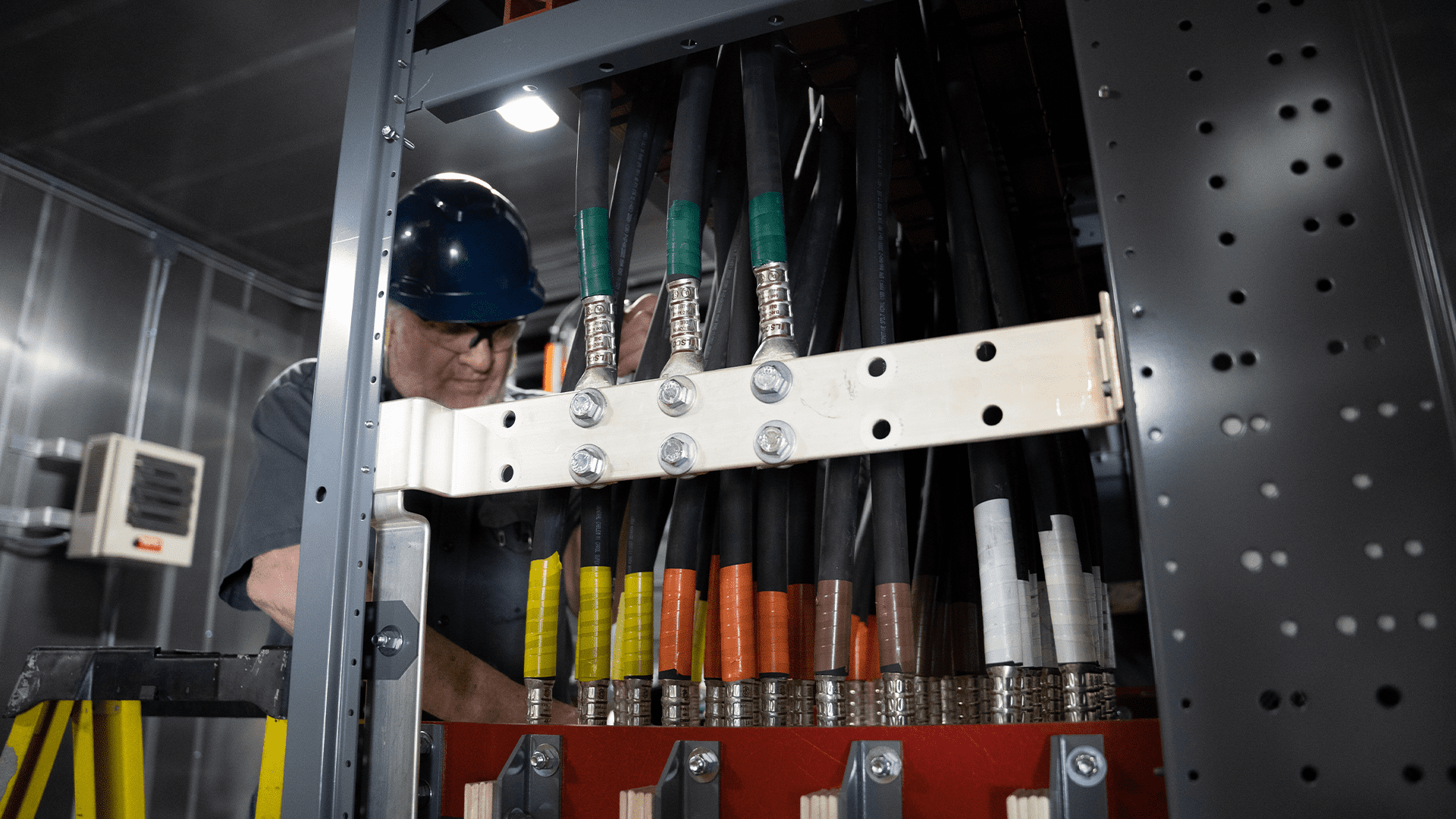 electrician working on large wires Acoustical Sheetmetal Company