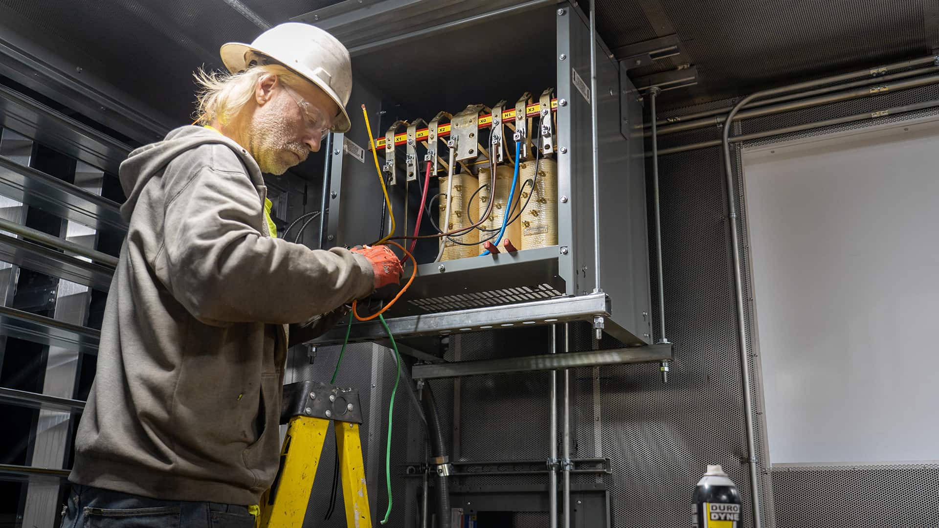 electrician working on wiring Acoustical Sheetmetal Company