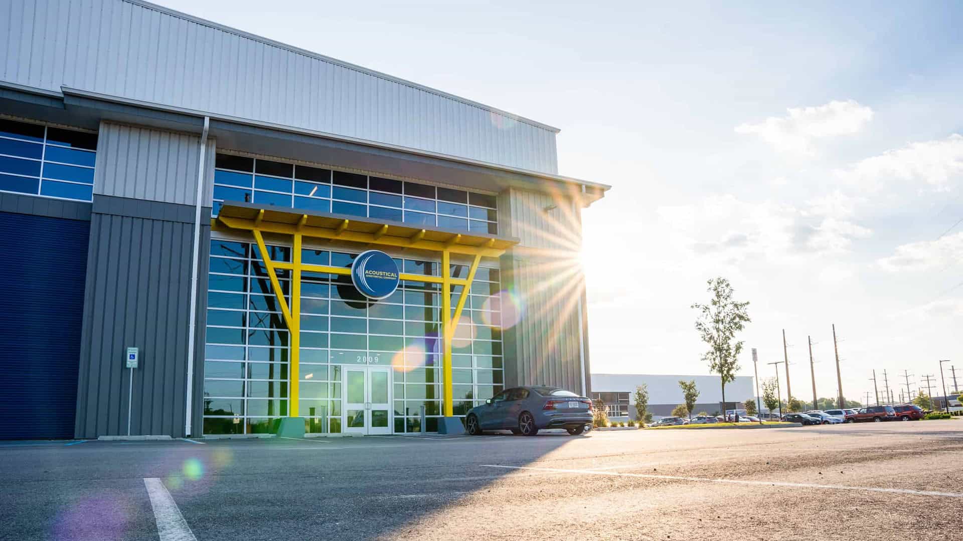 Acoustical Sheetmetal Company's Hudome Way entrance on a sunny day.